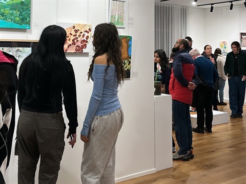 young people looking at artwork 