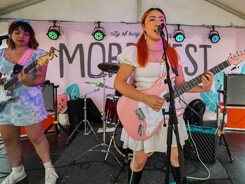 Two band members performing on stage at Mordi Fest 