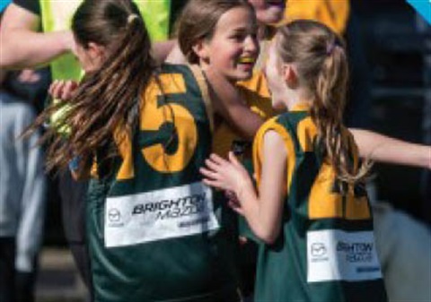 3 young people playing football 