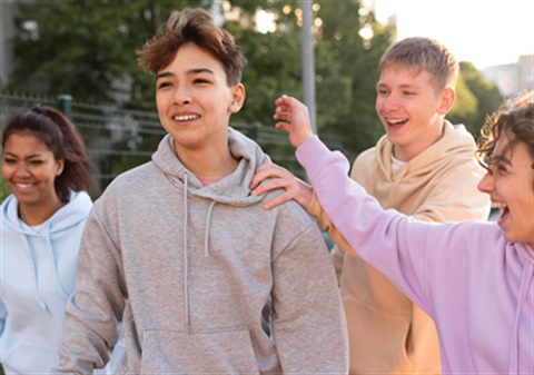 four young people laughing 